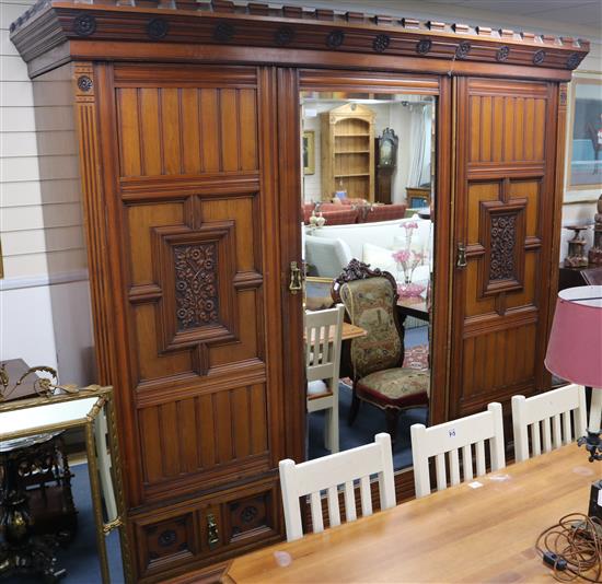 An Arts & Crafts walnut triple wardrobe, W.255cm